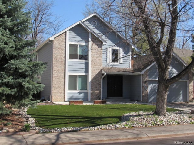 view of front of property featuring brick siding, a front yard, and an attached garage