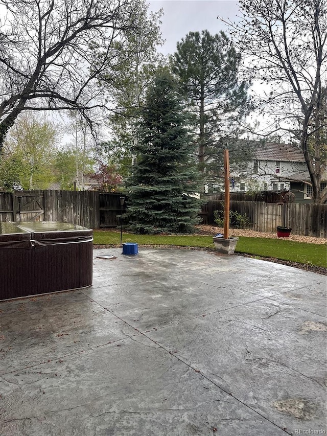 view of patio / terrace with a hot tub and a fenced backyard
