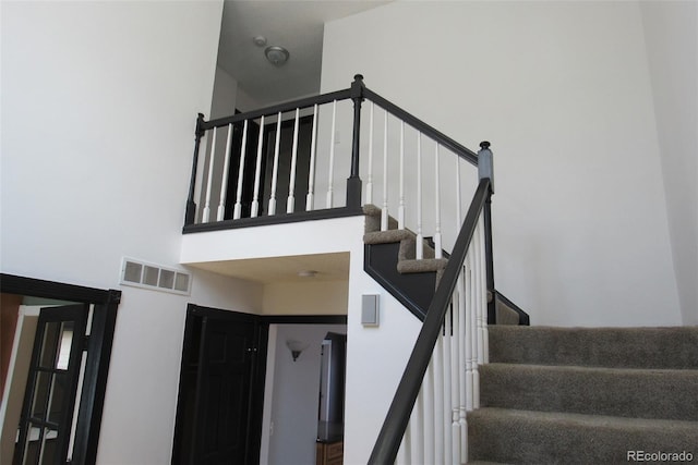12381 E Vassar Dr, Aurora, CO 80014 - staircase with a high ceiling