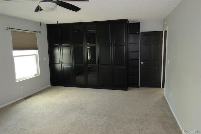 12381 E Vassar Dr, Aurora, CO 80014 - unfurnished bedroom with light carpet, baseboards, and ceiling fan