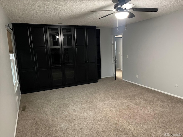 12381 E Vassar Dr, Aurora, CO 80014 - carpeted spare room featuring a ceiling fan, a textured ceiling, and baseboards