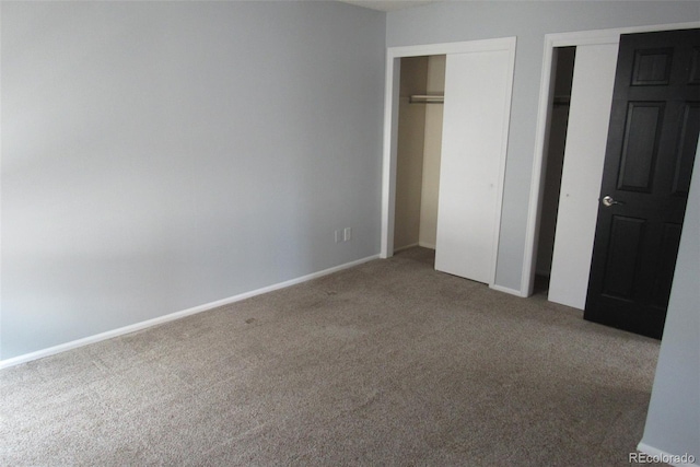12381 E Vassar Dr, Aurora, CO 80014 - unfurnished bedroom featuring carpet floors, two closets, and baseboards