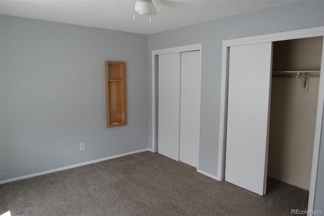 12381 E Vassar Dr, Aurora, CO 80014 - unfurnished bedroom featuring two closets, carpet floors, ceiling fan, and a textured ceiling
