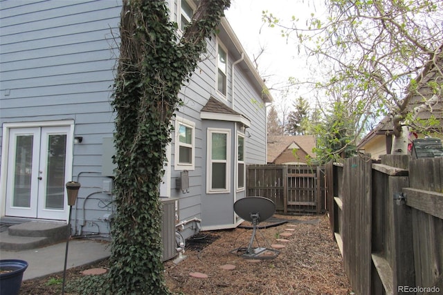 12381 E Vassar Dr, Aurora, CO 80014 - view of property exterior featuring french doors and fence