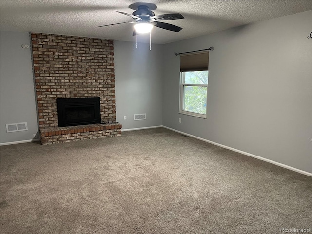 12381 E Vassar Dr, Aurora, CO 80014 - unfurnished living room with a textured ceiling, ceiling fan, carpet, a fireplace, and baseboards