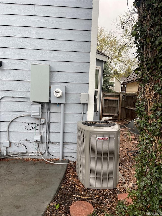 12381 E Vassar Dr, Aurora, CO 80014 - exterior view of central air condition unit, electric meter, and fence