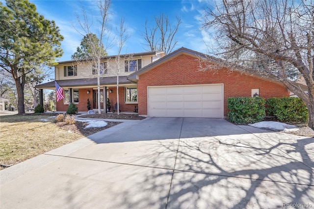 traditional-style home with a garage, concrete driveway, brick siding, and a porch