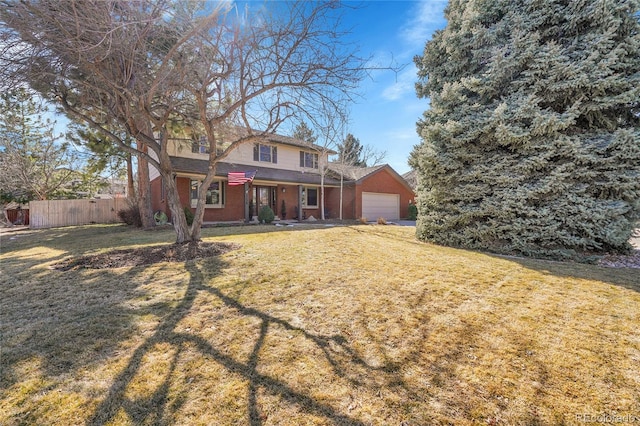 traditional home with a garage, fence, and a front yard