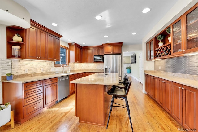 kitchen with black appliances, light wood-type flooring, and open shelves