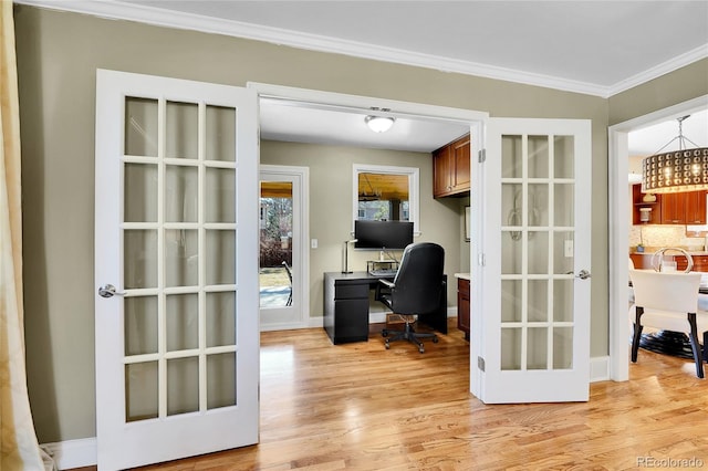 office space with baseboards, french doors, light wood-type flooring, and crown molding