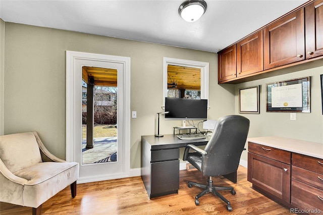 office area featuring light wood-type flooring and baseboards