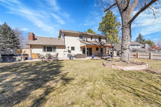 back of house with a jacuzzi, a chimney, a fenced backyard, a patio area, and outdoor lounge area