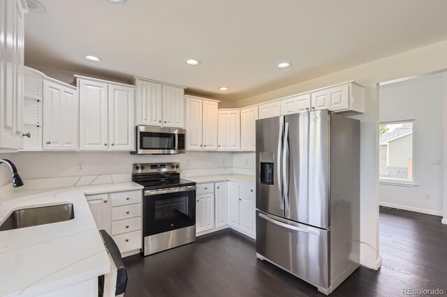 19033 E 22nd Cir, Aurora, CO 80011 - kitchen with stainless steel appliances, dark wood-type flooring, light stone countertops, white cabinets, and recessed lighting