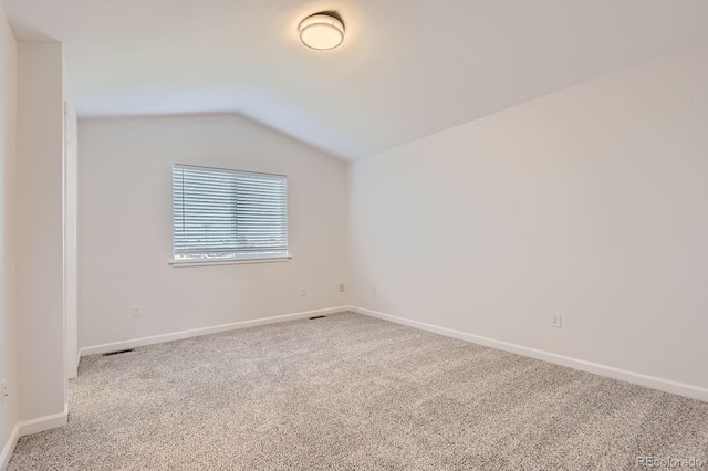 19033 E 22nd Cir, Aurora, CO 80011 - carpeted empty room featuring vaulted ceiling and baseboards