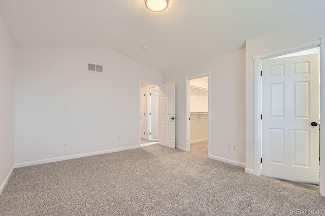 19033 E 22nd Cir, Aurora, CO 80011 - unfurnished bedroom with carpet flooring, a spacious closet, lofted ceiling, and a closet