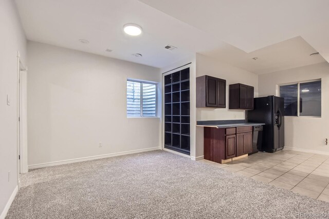 19033 E 22nd Cir, Aurora, CO 80011 - kitchen featuring black appliances, light colored carpet, dark brown cabinetry, and light tile patterned floors