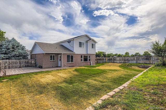 19033 E 22nd Cir, Aurora, CO 80011 - rear view of property with a fenced backyard, brick siding, and a wooden deck