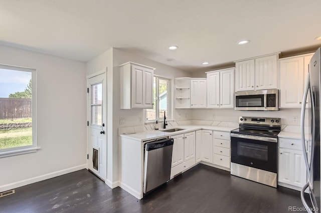 19033 E 22nd Cir, Aurora, CO 80011 - kitchen with appliances with stainless steel finishes, dark wood-style flooring, white cabinets, light countertops, and recessed lighting