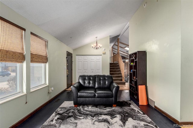 living area with lofted ceiling, baseboards, stairs, and a chandelier