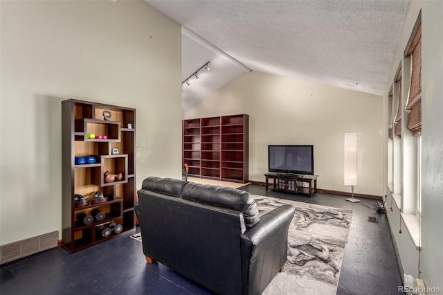 living area with baseboards, visible vents, rail lighting, a textured ceiling, and high vaulted ceiling