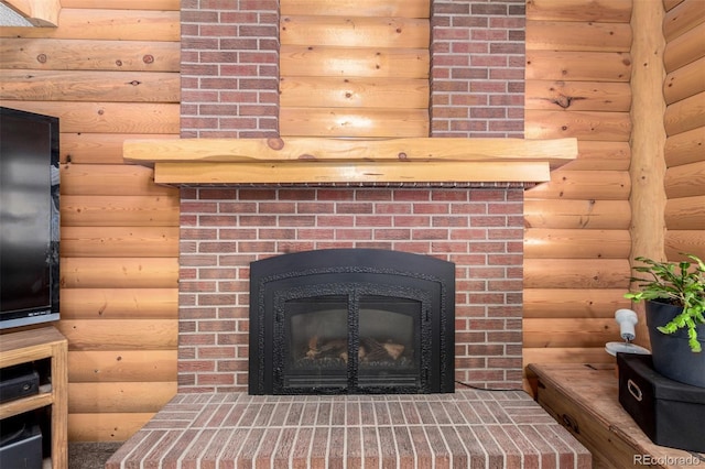 details featuring rustic walls and a brick fireplace