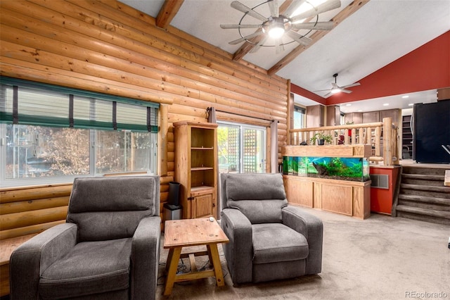 living room with lofted ceiling with beams, rustic walls, carpet, and a ceiling fan