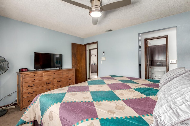 carpeted bedroom with a textured ceiling, ceiling fan, and visible vents