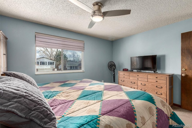 bedroom featuring a ceiling fan, carpet flooring, a textured ceiling, and baseboards