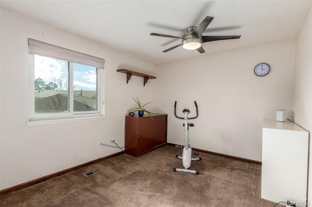 exercise room with baseboards, visible vents, a ceiling fan, carpet, and a textured ceiling