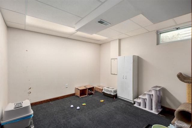 miscellaneous room featuring a paneled ceiling, carpet, visible vents, and baseboards