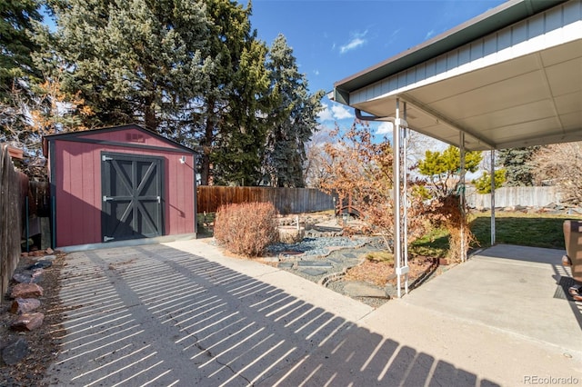 view of patio featuring a storage shed, an outdoor structure, and fence