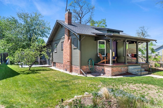 4321 Winona Ct, Denver, CO 80212 - view of front of home featuring a chimney, a porch, a front yard, and roof with shingles
