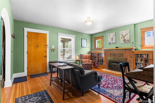 4321 Winona Ct, Denver, CO 80212 - living room with healthy amount of natural light, a fireplace, wood finished floors, and baseboards