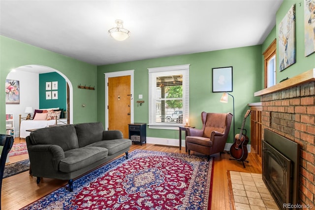 4321 Winona Ct, Denver, CO 80212 - living room with a fireplace, arched walkways, wood finished floors, and baseboards