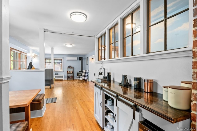 4321 Winona Ct, Denver, CO 80212 - bar area featuring a wall mounted air conditioner and light wood-style floors