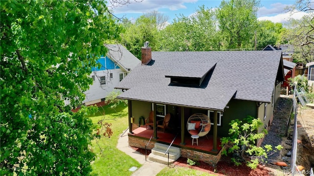 4321 Winona Ct, Denver, CO 80212 - view of front of home featuring a porch, a shingled roof, a chimney, and a front yard