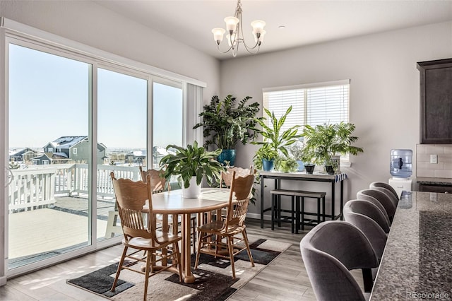 dining space featuring a chandelier and light hardwood / wood-style flooring