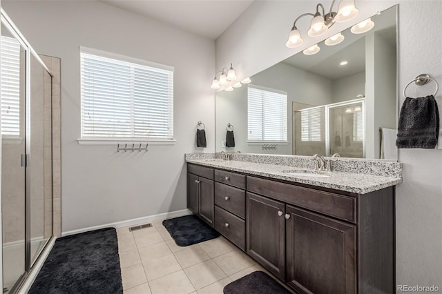 bathroom featuring vanity, a shower with door, and tile patterned flooring