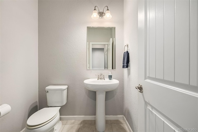 bathroom featuring tile patterned flooring, sink, and toilet