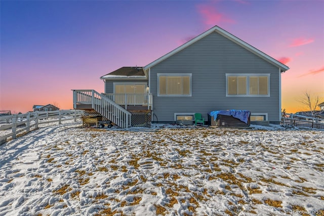 snow covered property with a wooden deck