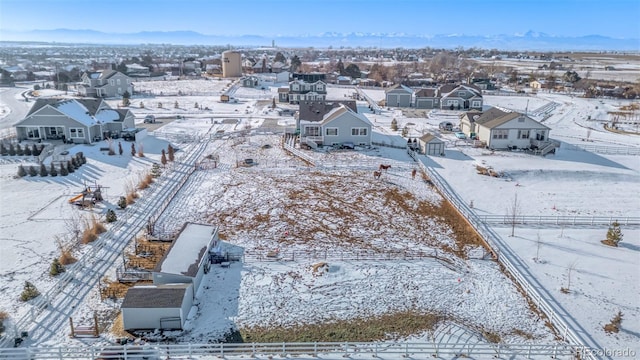 snowy aerial view featuring a mountain view