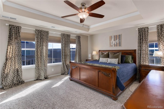 bedroom with light carpet, visible vents, a raised ceiling, and ornamental molding