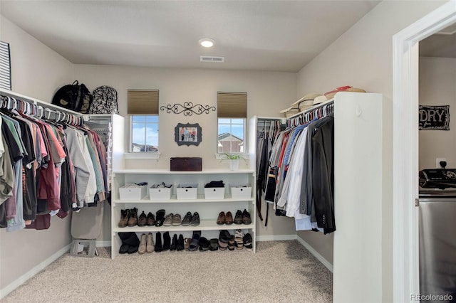 walk in closet with washer / dryer, carpet flooring, and visible vents