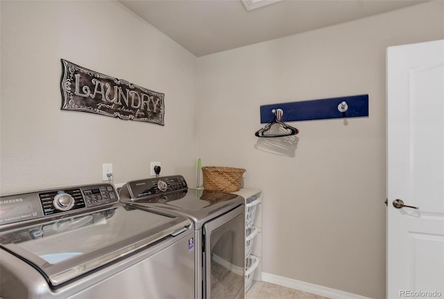 laundry area with baseboards, laundry area, and washer and clothes dryer