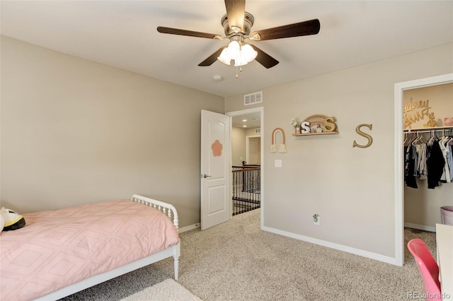 carpeted bedroom featuring a ceiling fan, baseboards, visible vents, a spacious closet, and a closet