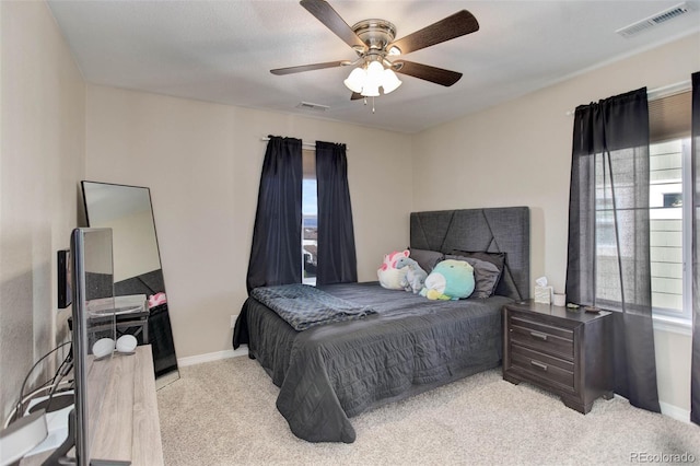 bedroom with ceiling fan, baseboards, visible vents, and light carpet