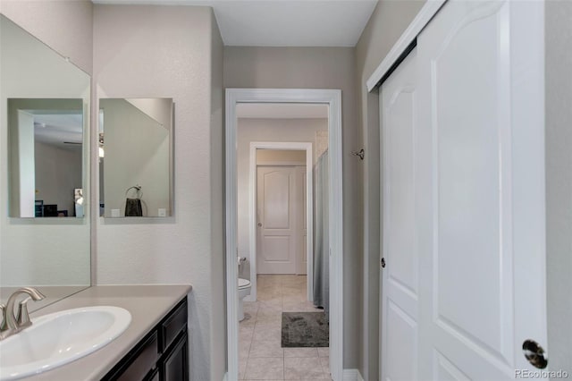 bathroom featuring vanity, toilet, and tile patterned flooring