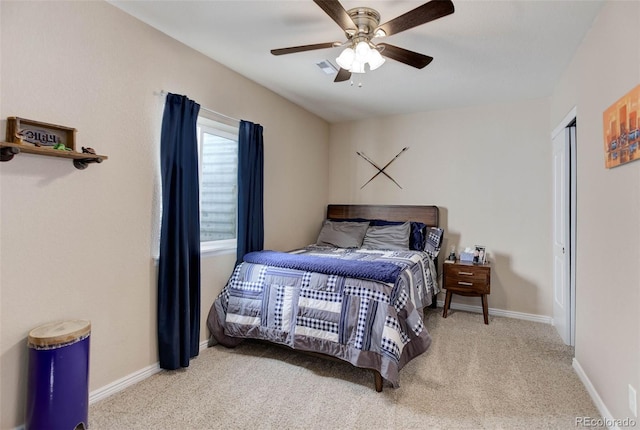 carpeted bedroom with visible vents, baseboards, and ceiling fan