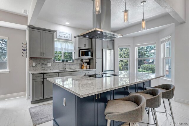 4013 S Carson St Unit C, Aurora, CO 80014 - kitchen featuring appliances with stainless steel finishes, island range hood, gray cabinetry, a sink, and baseboards