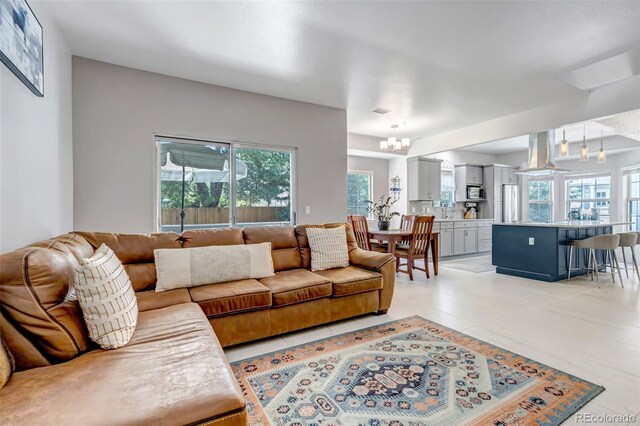 4013 S Carson St Unit C, Aurora, CO 80014 - living room featuring a chandelier, healthy amount of natural light, and light tile patterned floors